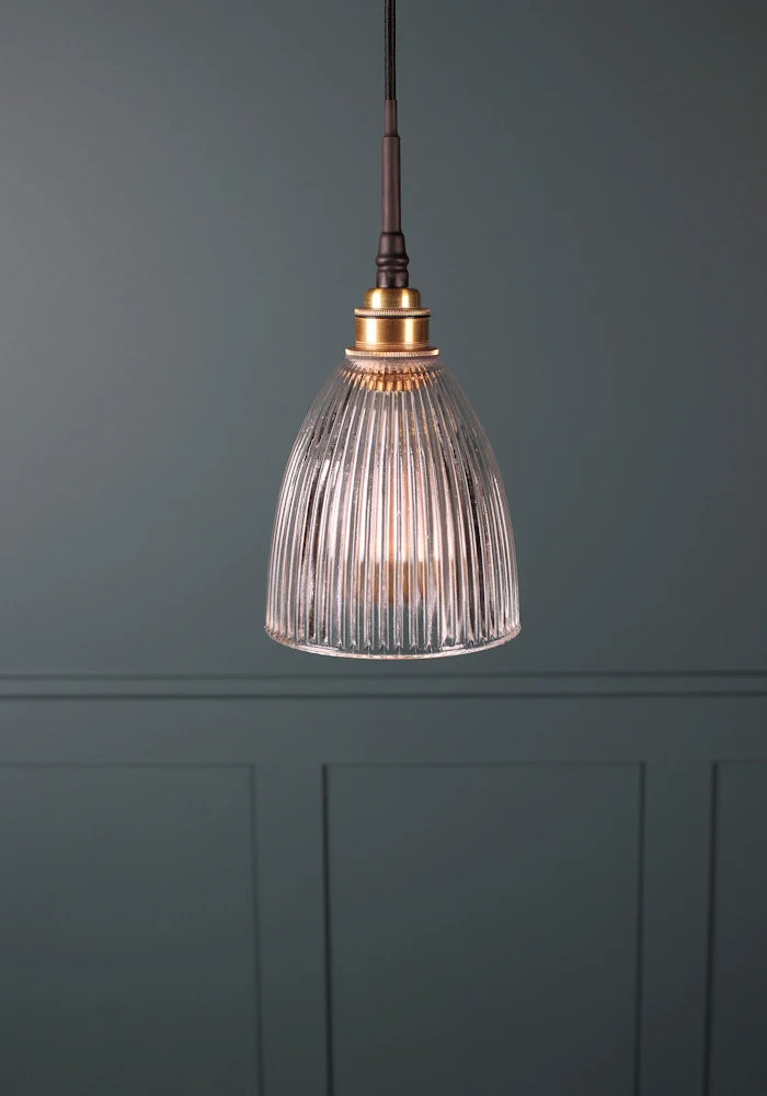 Small bell shaped ribbed glass bathroom pendant light with brushed brass lamp holder and black fabric flex 