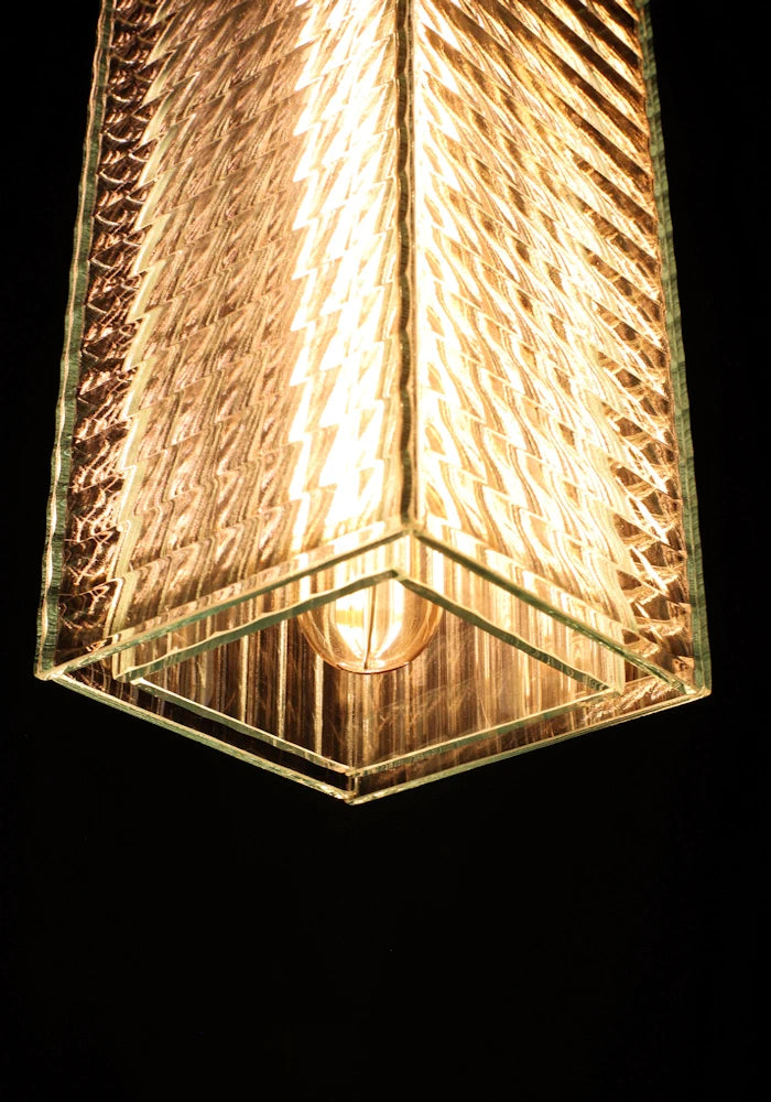 Close up of large ribbed glass bathroom pendant light  