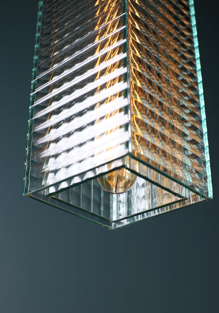 Close up of large ribbed glass bathroom pendant light  switched off 