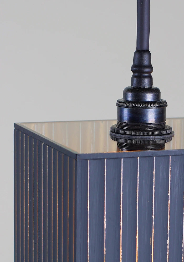 Close up of black and gold ribbed glass bathroom pendant light with antique bronze lamp holder