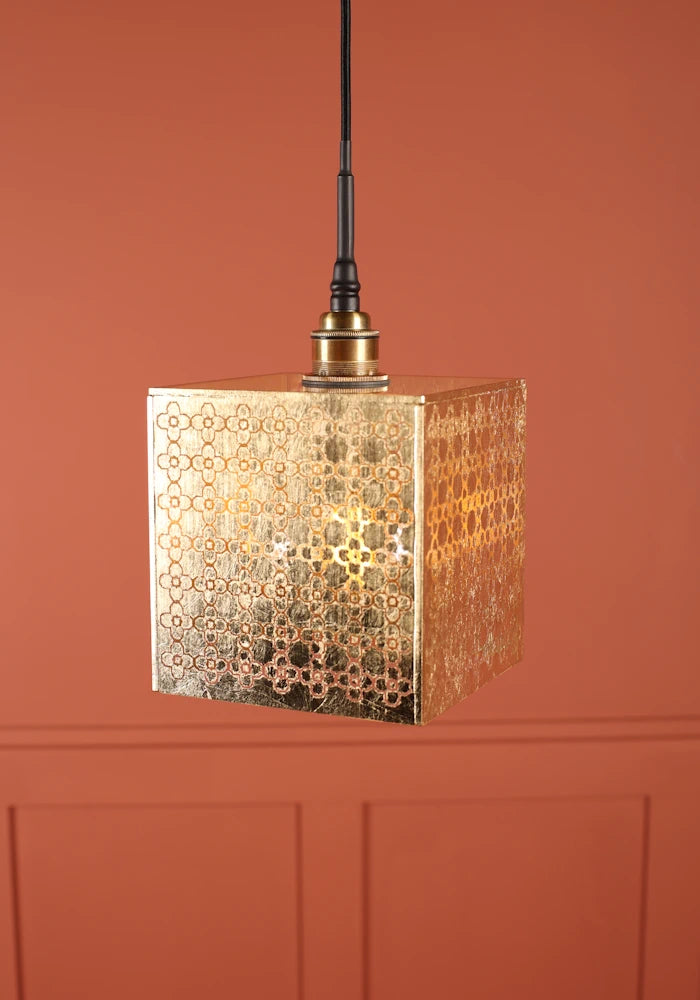 Large square Moroccan patterned gold bathroom with brushed brass lamp holder.