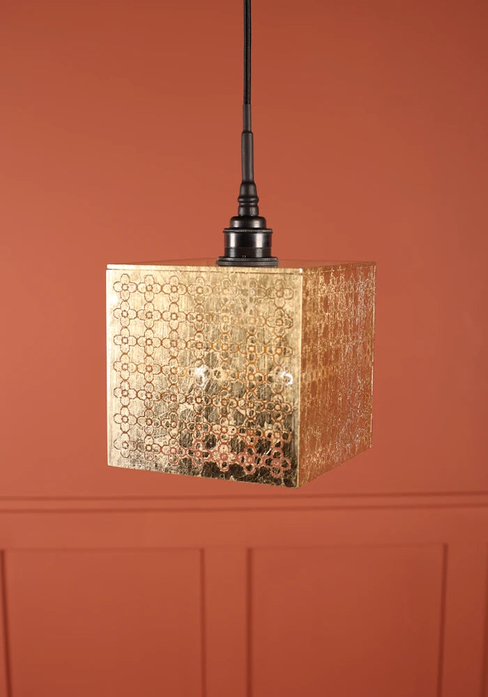 Large square Moroccan patterned gold bathroom with antique bronze lamp holder.