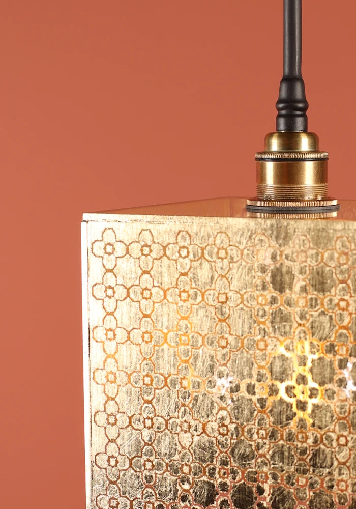 Close up of large square Moroccan patterned gold bathroom pendant light