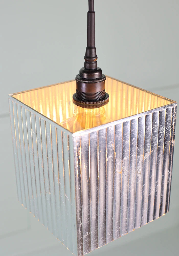 Close up of large square silver leaf bathroom pendant light.