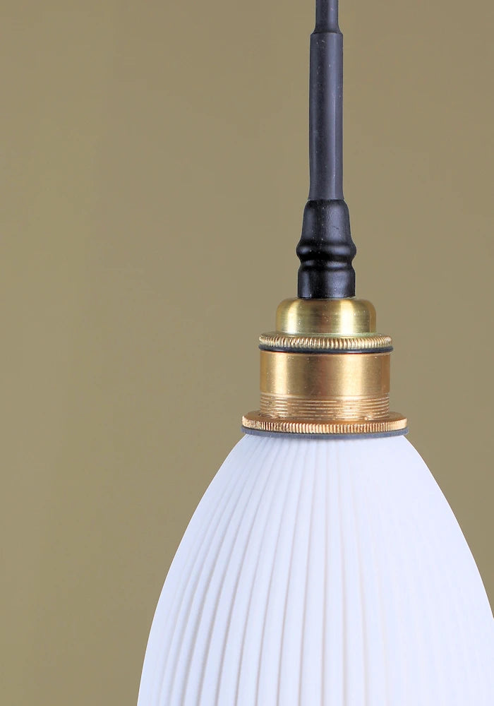 Ribbed porcelain bathroom pendant light with brushed brass lamp holder.