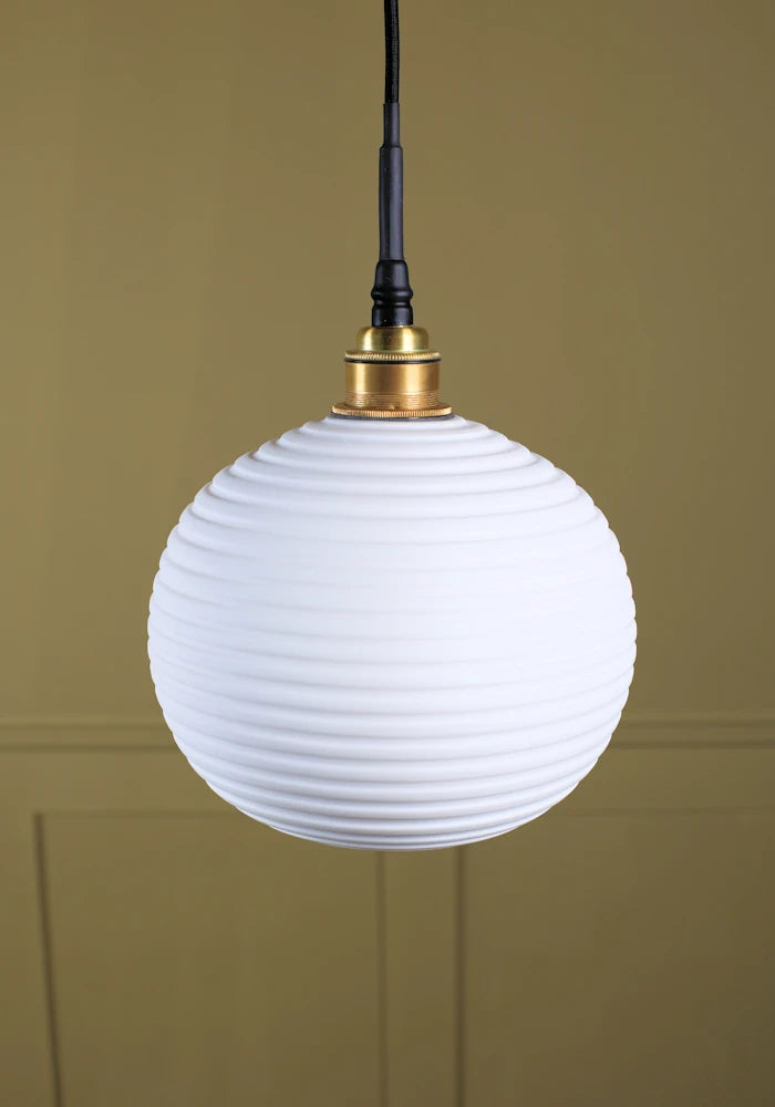 Large spherical porcelain bathroom pendant light with brushed brass lamp holder.