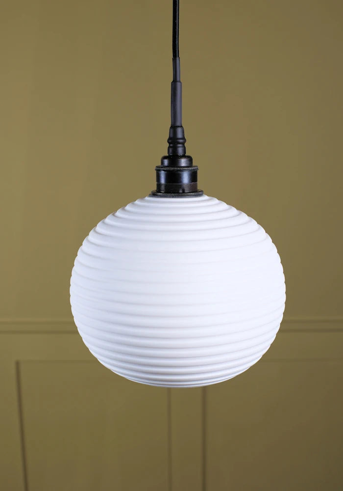 Large spherical porcelain bathroom pendant light with antique bronze lamp holder.