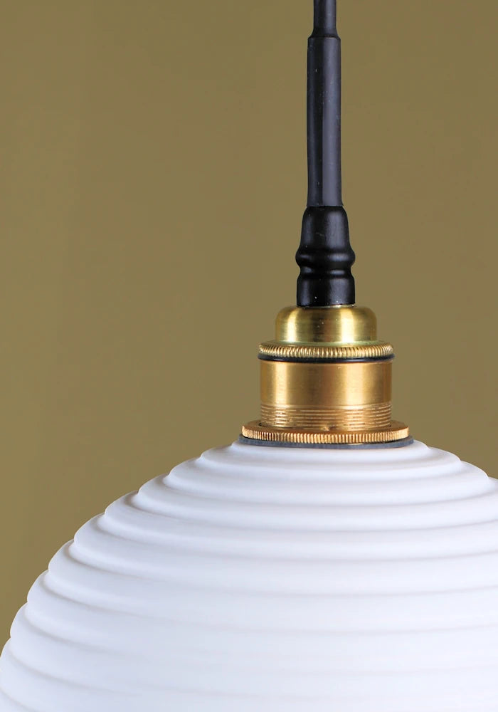 Optic porcelain bathroom pendant light with brass lamp holder.