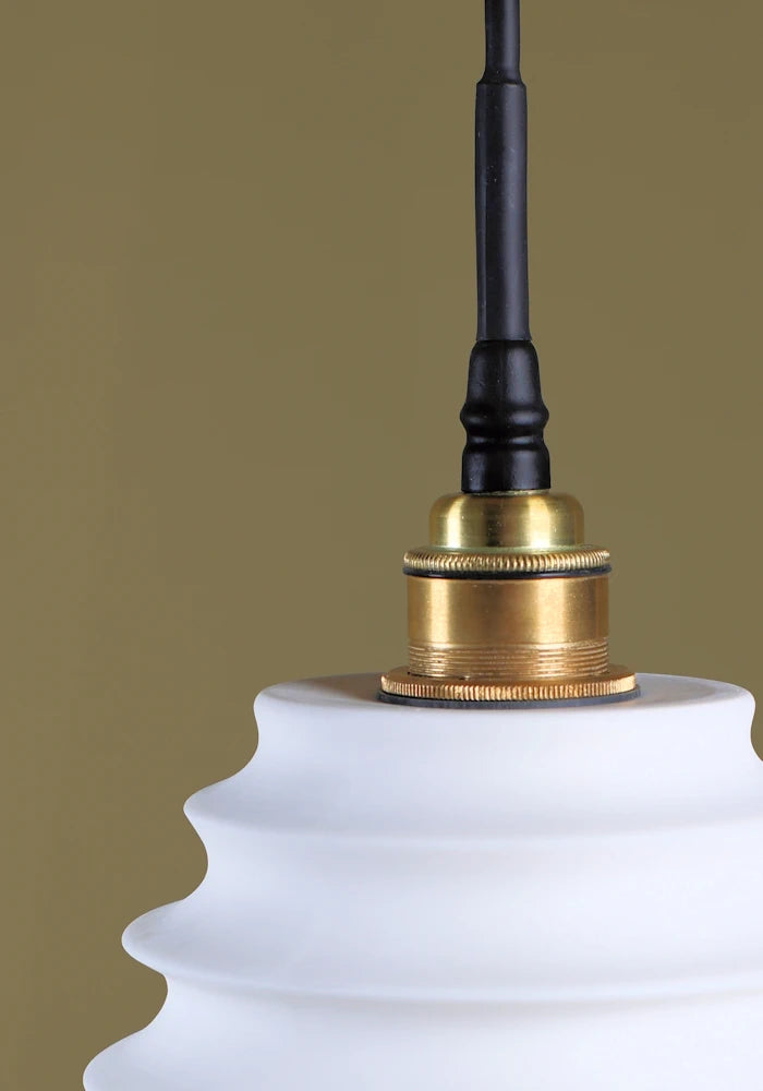 Concertina style porcelain bathroom pendant light with brushed brass lamp holder.