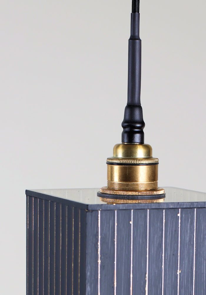 Black and gold bathroom pendant light with brass lamp holder.