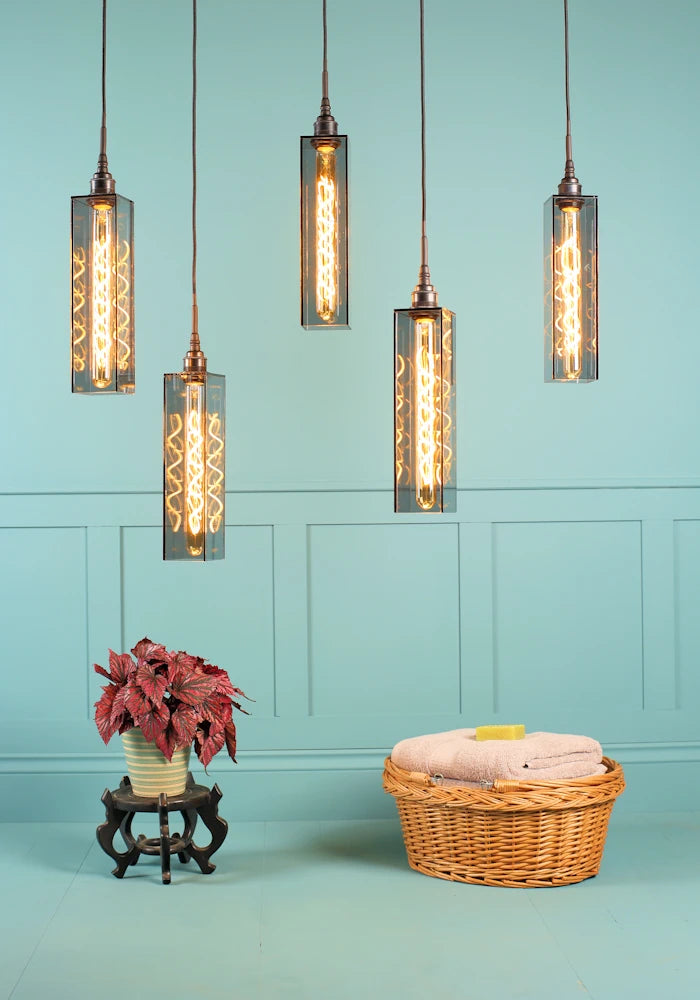 5 elongated rectangular smoked glass cluster bathroom pendant light, plant and bath towels.