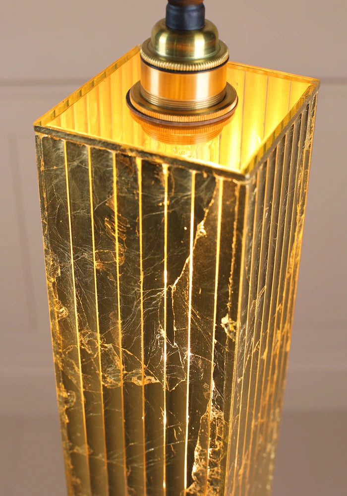 Close up image of long rectangular gold leaf bathroom pendant light.