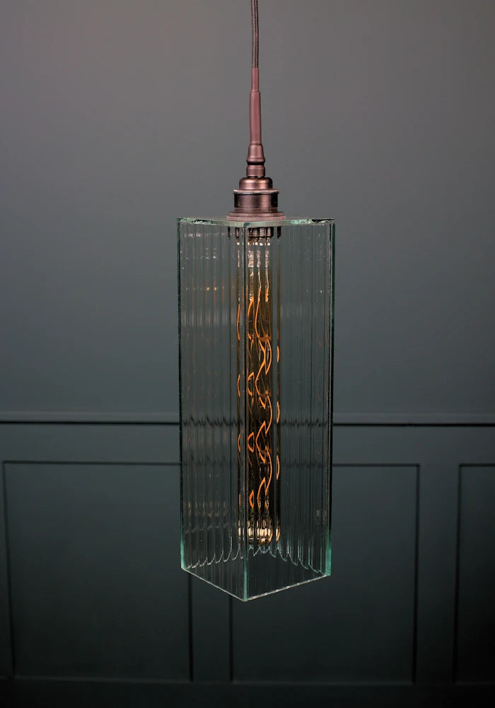 Long rectangular fluted glass bathroom pendant light with antique bronze lamp holder.