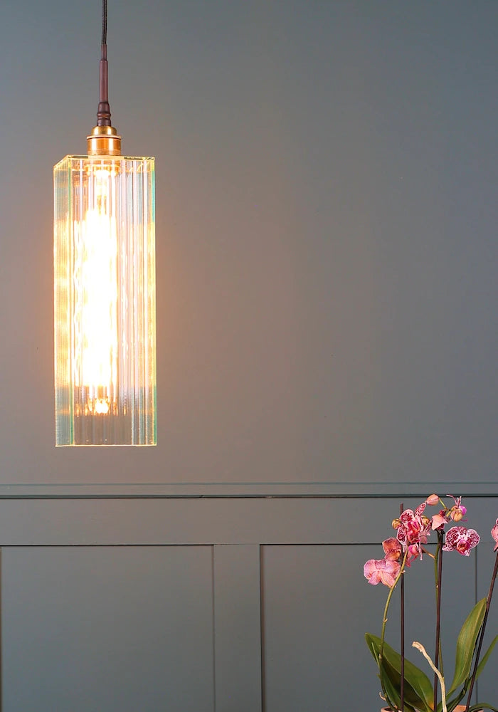 Close up of long rectangular fluted glass bathroom pendant light.