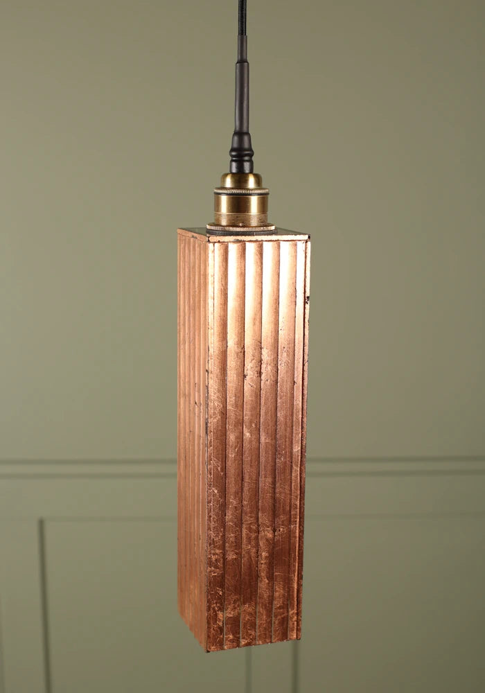 Elongated copper leaf bathroom pendant light with brushed brass lamp holder.