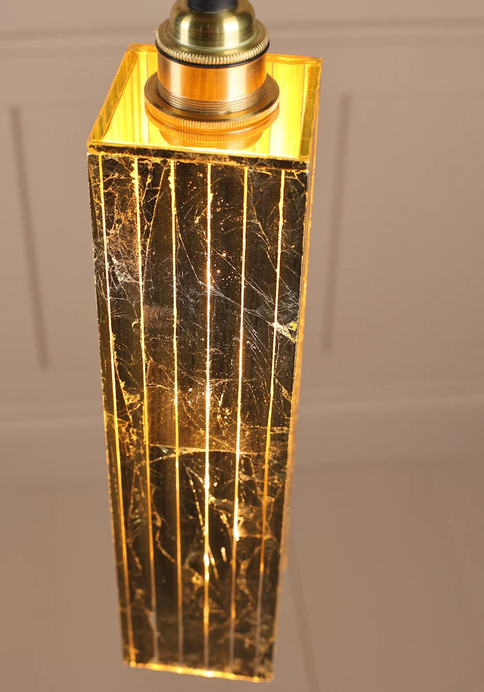 Close up of long rectangular gold leaf bathroom pendant light.