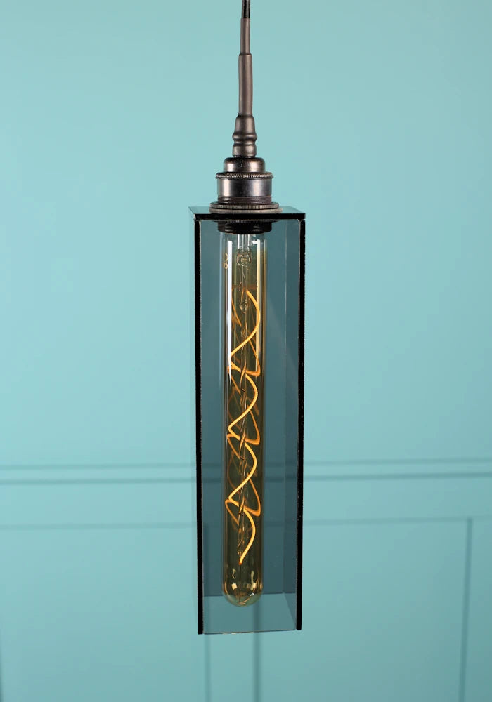 Elongated rectangular smoked glass bathroom pendant light with antique bronze lamp holder.