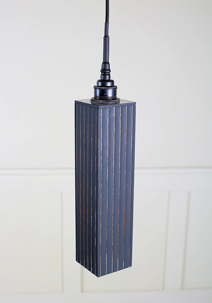 Black and gold bathroom ribbed glass pendant light with antique bronze lamp holder.