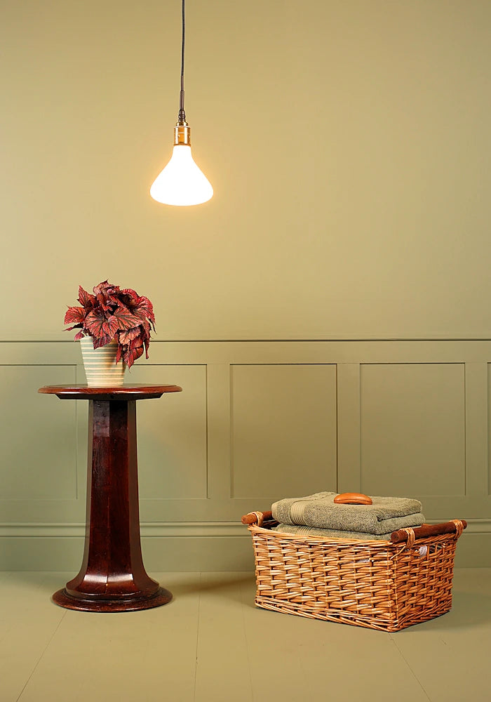 Tala Noma bathroom pendant light with plant and basket of towels.