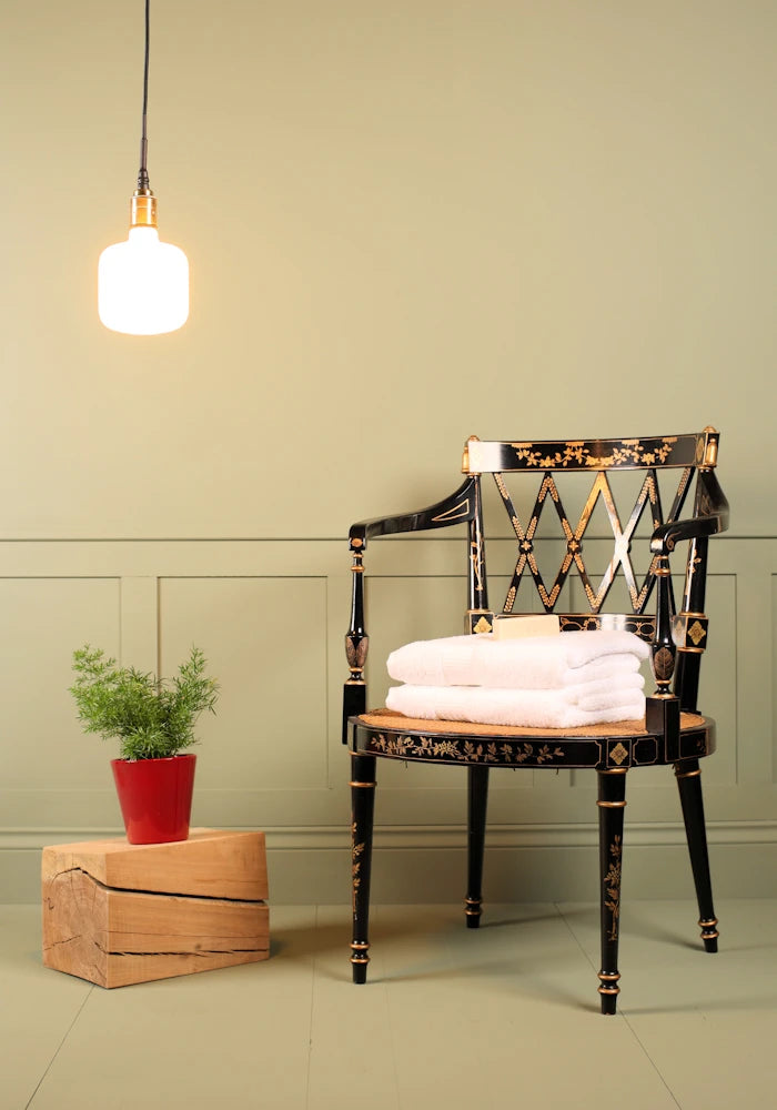 Tala Oblo bathroom pendant light, plant and ornate chair.