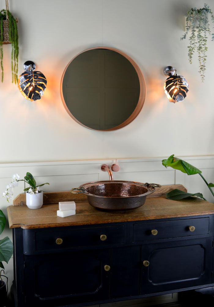 Industrial-style metal bathroom wall light, nickel base, plant.